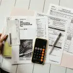 working on tax forms with calculator