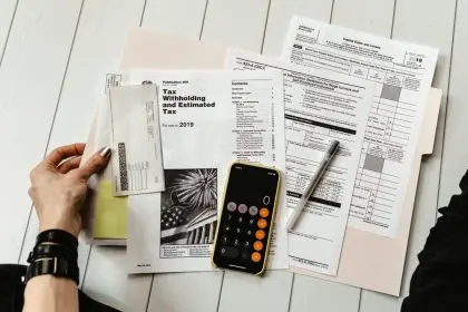 working on tax forms with calculator