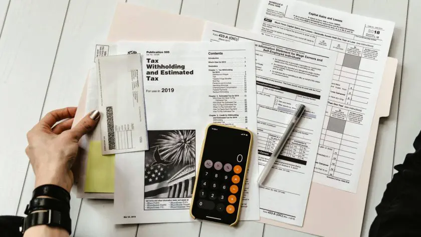 working on tax forms with calculator