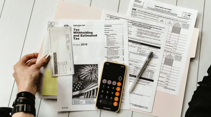 working on tax forms with calculator